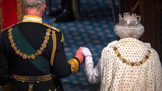 Reina Isabell II de la mano con el rey Carlos III