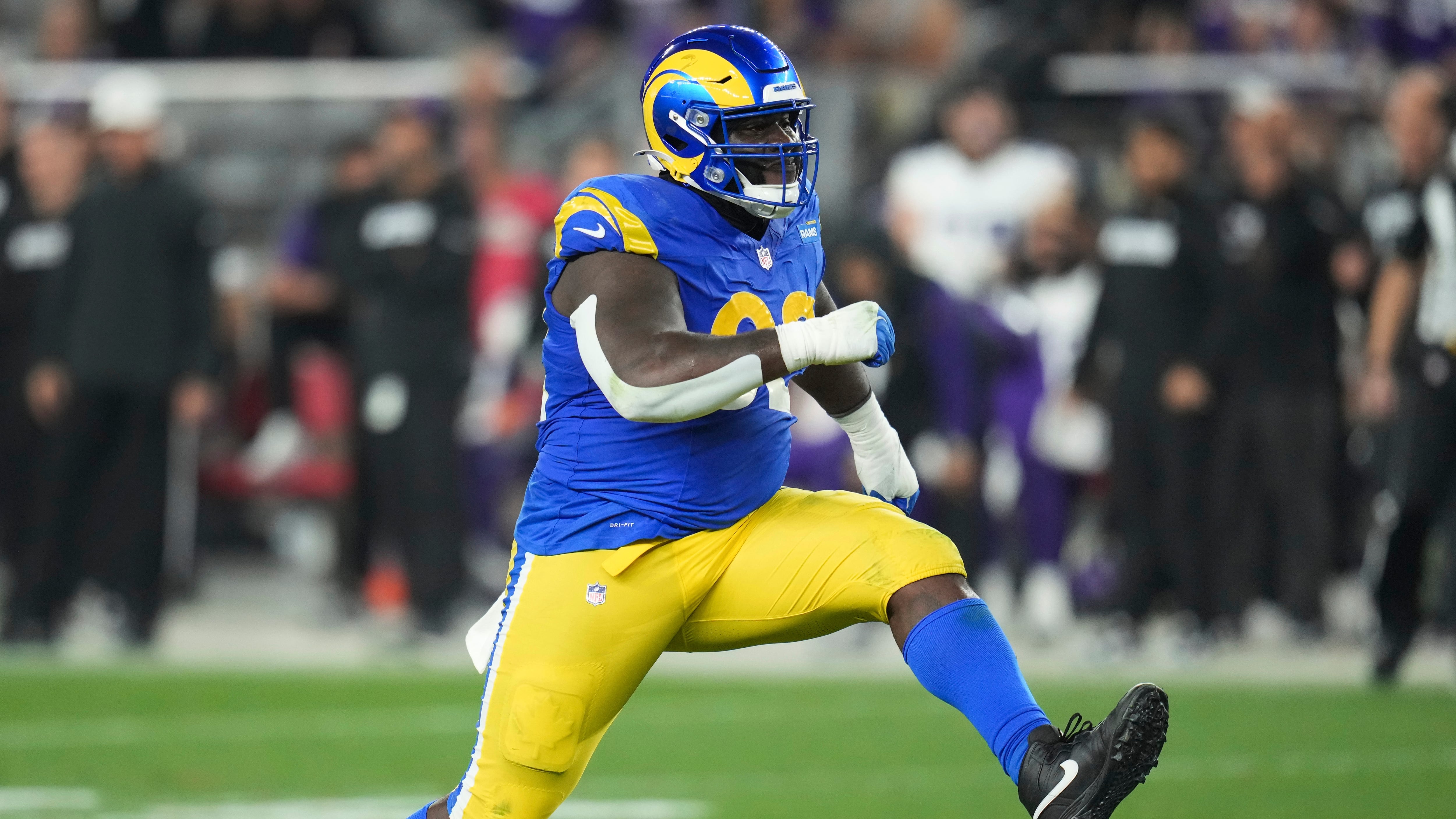 Los Angeles Rams defensive tackle Neville Gallimore (92) reacts to sacking Minnesota Vikings quarterback Sam Darnold during the second half of an NFL wild card playoff football game, Monday, Jan. 13, 2025, in Glendale, Ariz. (AP Photo/Ross D. Franklin)