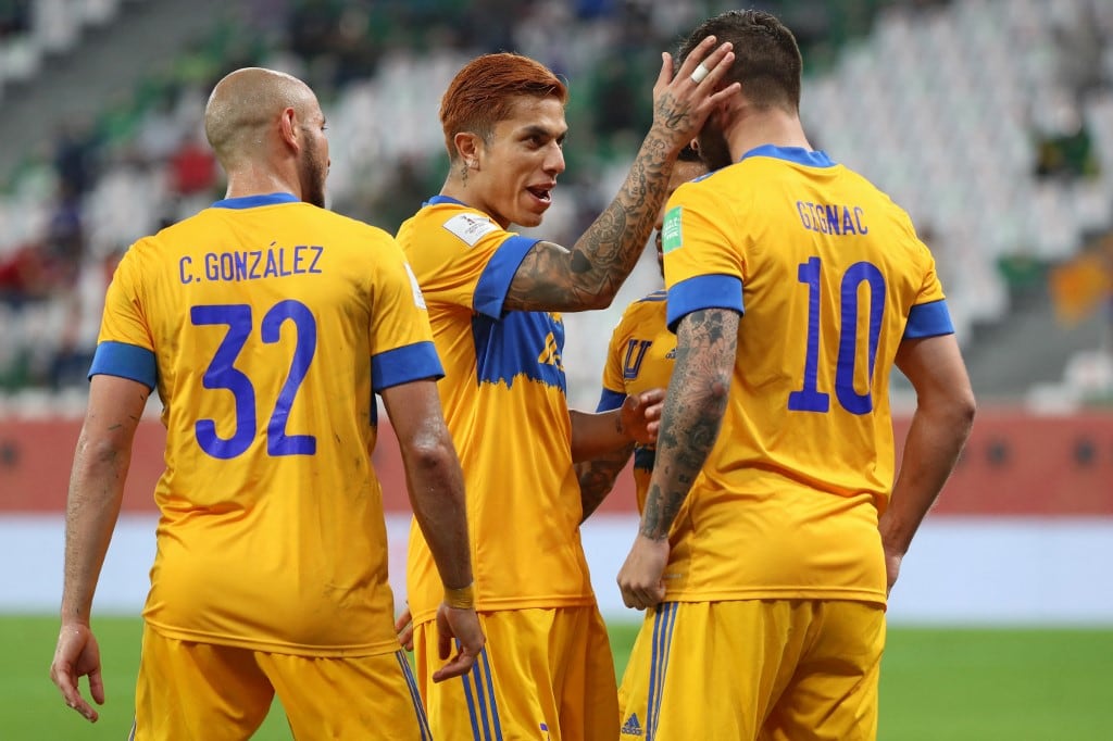 Tigres' forward Andre-Pierre Gignac (R) celebrates his goal with teammates during the FIFA Club World Cup semi-final football match between Brazil's Palmeiras and Mexico's UANL Tigres at the Ahmed bin Ali Stadium in the Qatari city of Ar-Rayyan on February 7, 2021. (Photo by Karim JAAFAR / AFP)