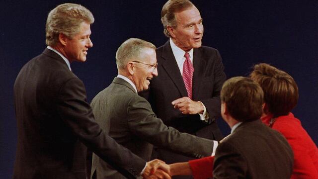 Los ex candidatos presidenciales Bill Clinton, Ross Perot y el presidente George Bush dan la mano a los panelistas después de la conclusión de su debate final en East Lansing, Michigan.