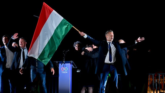 Peter Magyar, leader of the opposition Tisza party, waves the Hungarian flag following the announcement of the partial results of the parliamentary election, in Budapest, Hungary, Sunday, April 12, 2026. (AP Photo/Denes Erdos)