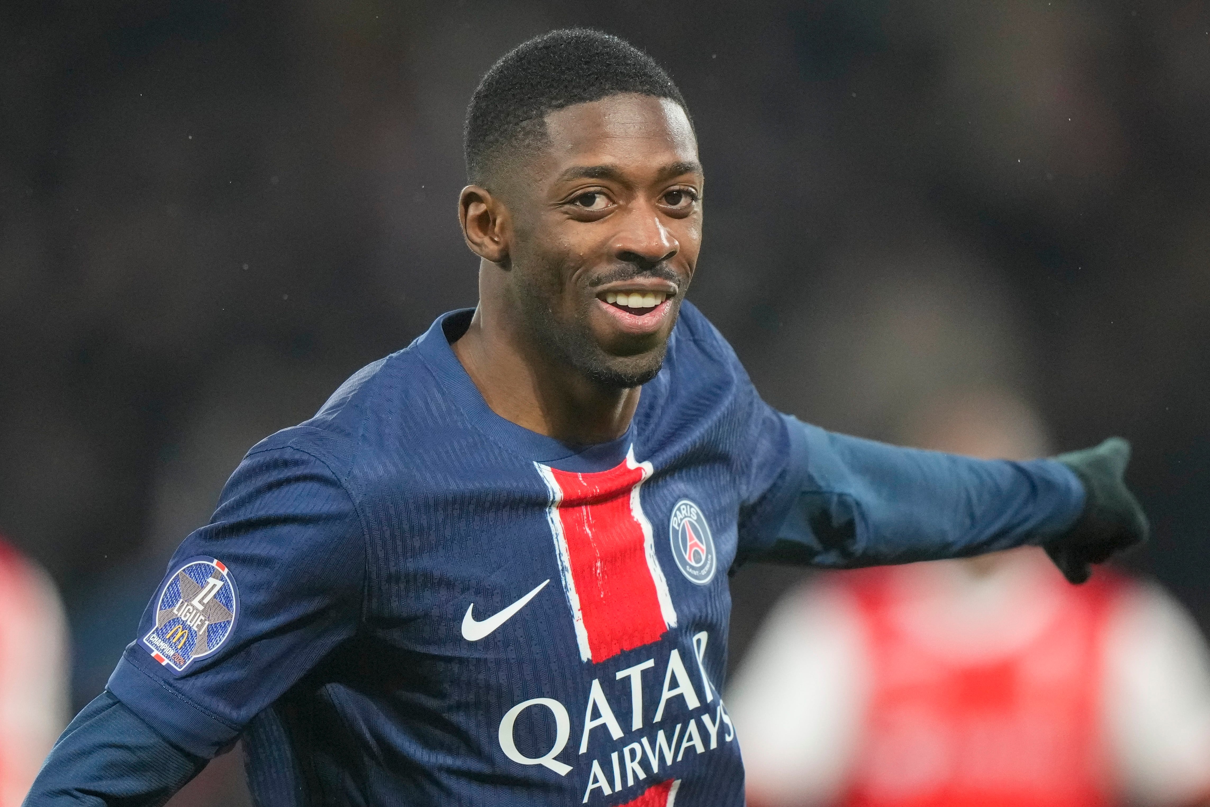 PSG's Ousmane Dembele celebrates after scoring the opening goal during the French League One soccer match between Paris Saint-Germain and Reims at Parc des Princes stadium in Paris, Saturday, Jan. 25, 2025. (AP Photo/Michel Euler)