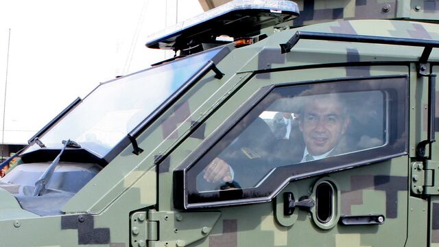 Felipe Calderón a bordo de un vehículo militar en 2011.