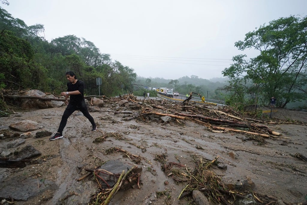 Camiones parados en una carretera bloqueada por un deslizamiento de tierra provocado por el huracán Otis cerca de Acapulco, México, el miércoles 25 de octubre de 2023.