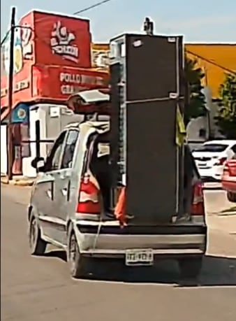 Conductor viajó con un refrigerador en la cajuela del coche