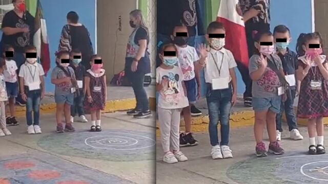 Niños saludan en honores a la bandera