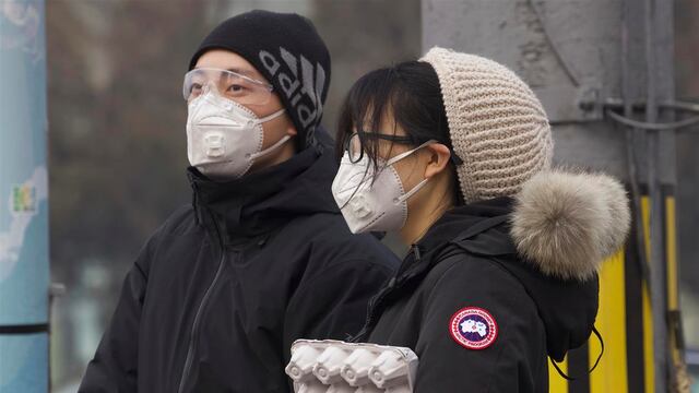 Personas usan mascarillas en Beijing.