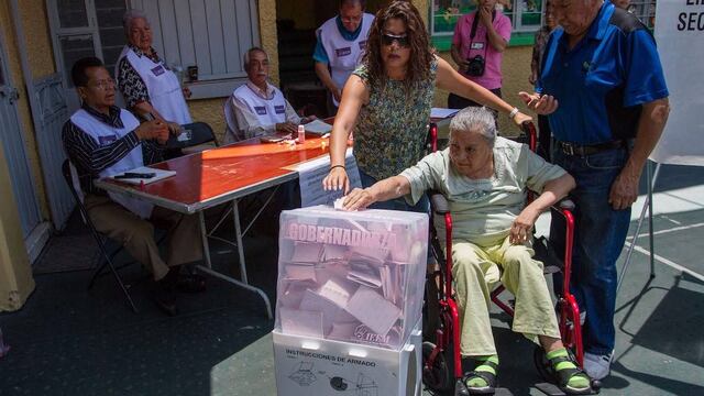 Una mujer emite su voto en una casilla del Edomex