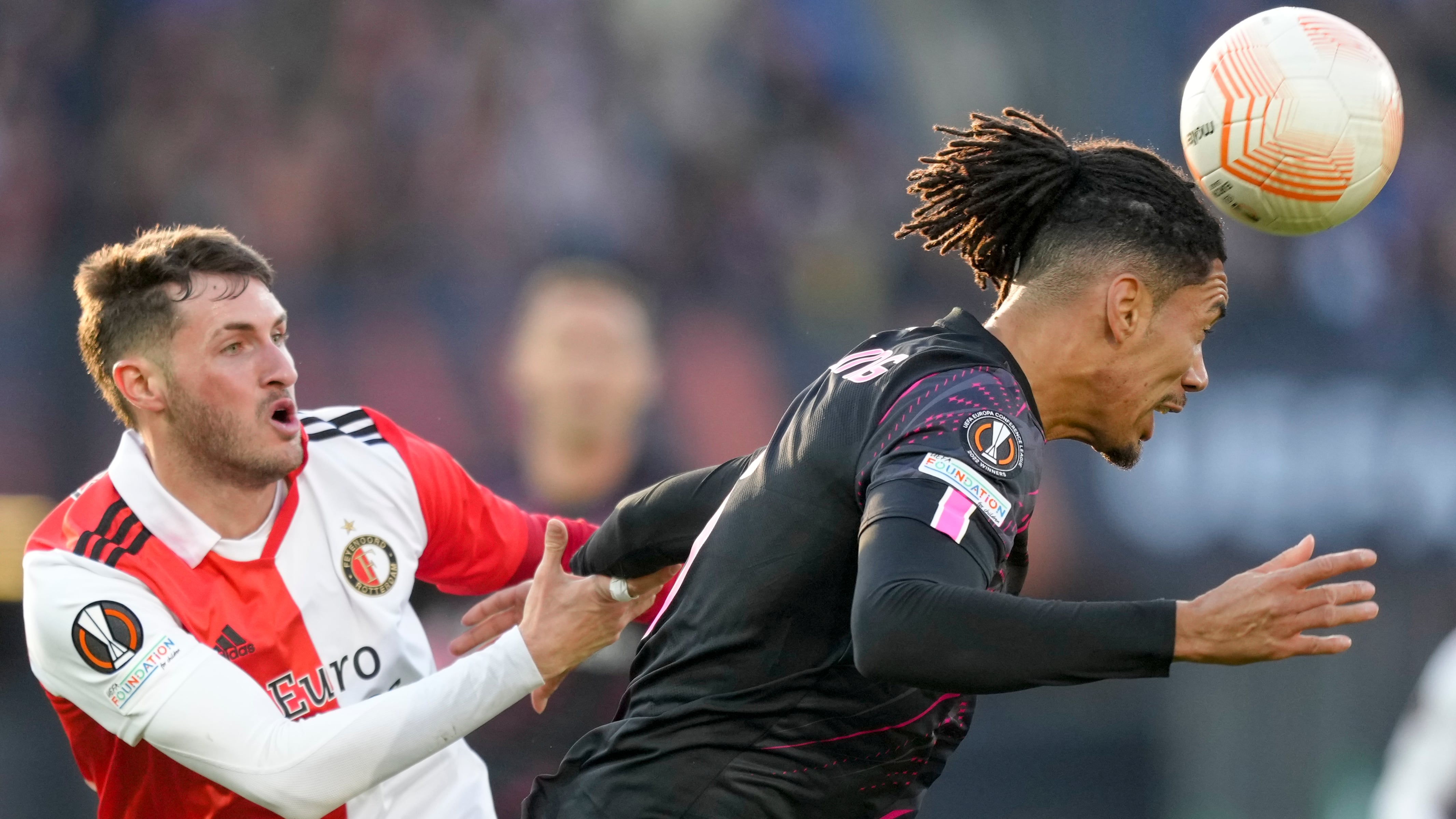 Feyenoord's Santiago Gimenez, left, duels for the ball with Roma's Chris Smalling during the first leg quarterfinal soccer match between Feyenoord and Roma at De Kuip stadium in Rotterdam, Netherlands, Thursday, April 13, 2023. (AP Photo/Peter Dejong)