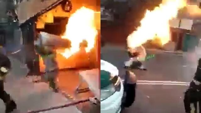 Bombero carga tanque de gas en llamas