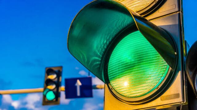 Traffic lights over urban intersection. Green light