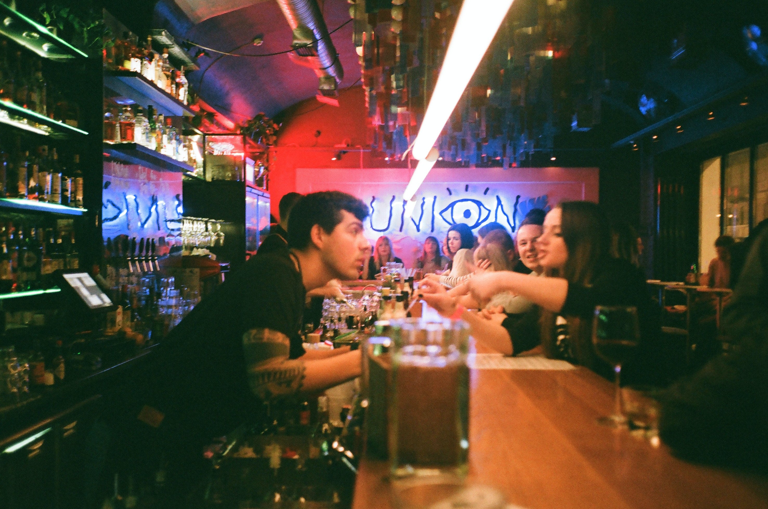 Personas en la barra de un bar.