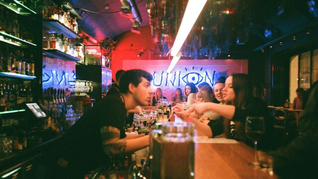 Personas en la barra de un bar.