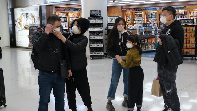 NEW YORK, NEW YORK - JANUARY 31: At the terminal that serves planes bound for China, people wear medical masks at John F. Kennedy Airport (JFK) out of concern over the Coronavirus on January 31, 2020 in New York City. The virus, which has so far killed over 200 people and infected an estimated 9,900 people, is believed to have started in the Chinese city of Wuhan.   Spencer Platt/Getty Images/AFP