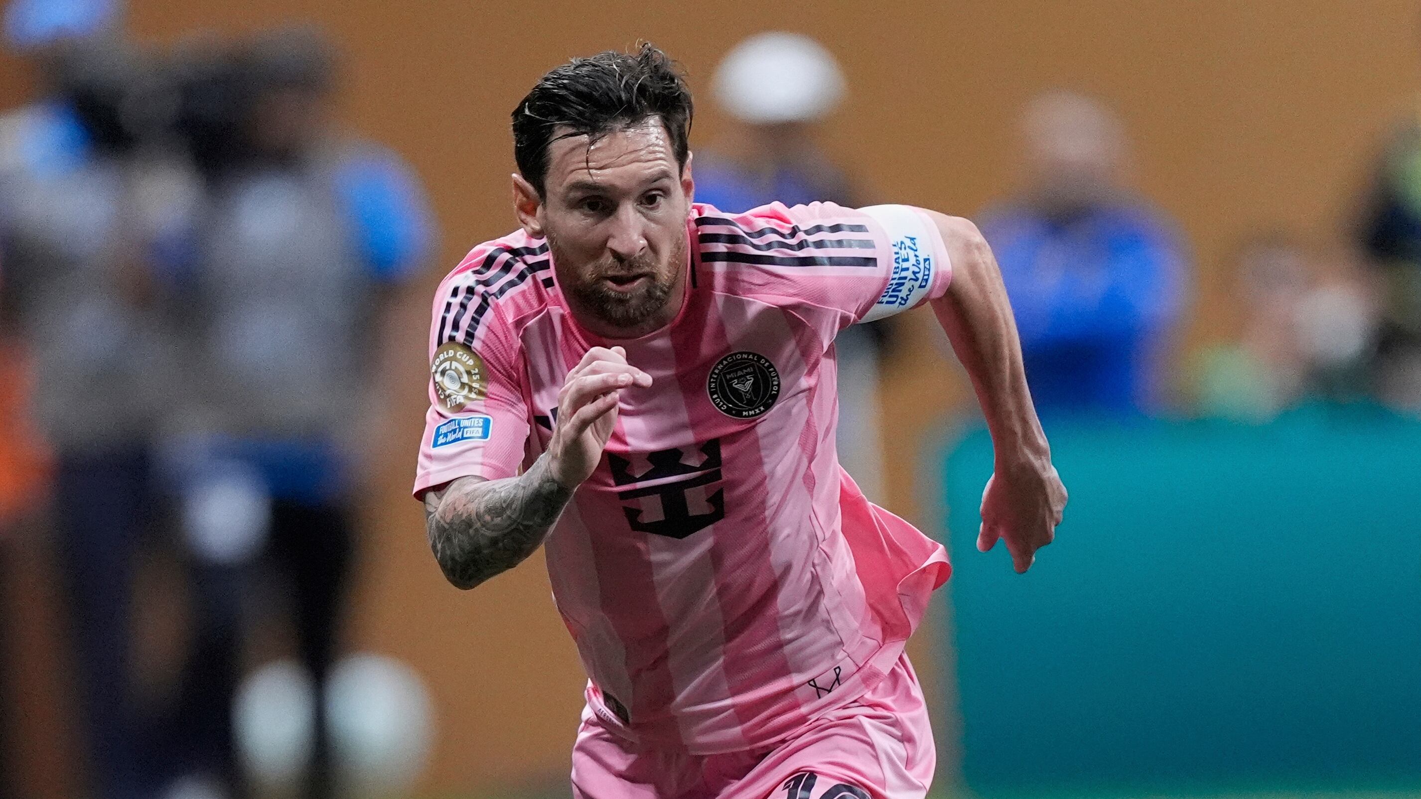 Inter Miami's Lionel Messi, left, and Porto's Gabri Veiga run for the ball during the Club World Cup group A soccer match between Inter Miami and FC Porto in Atlanta, Thursday, June 19, 2025. (AP Photo/Mike Stewart)
