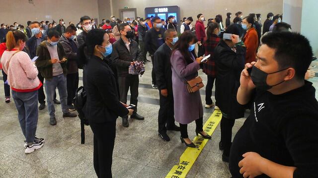 Gente en una estación de tren en Wuhan.