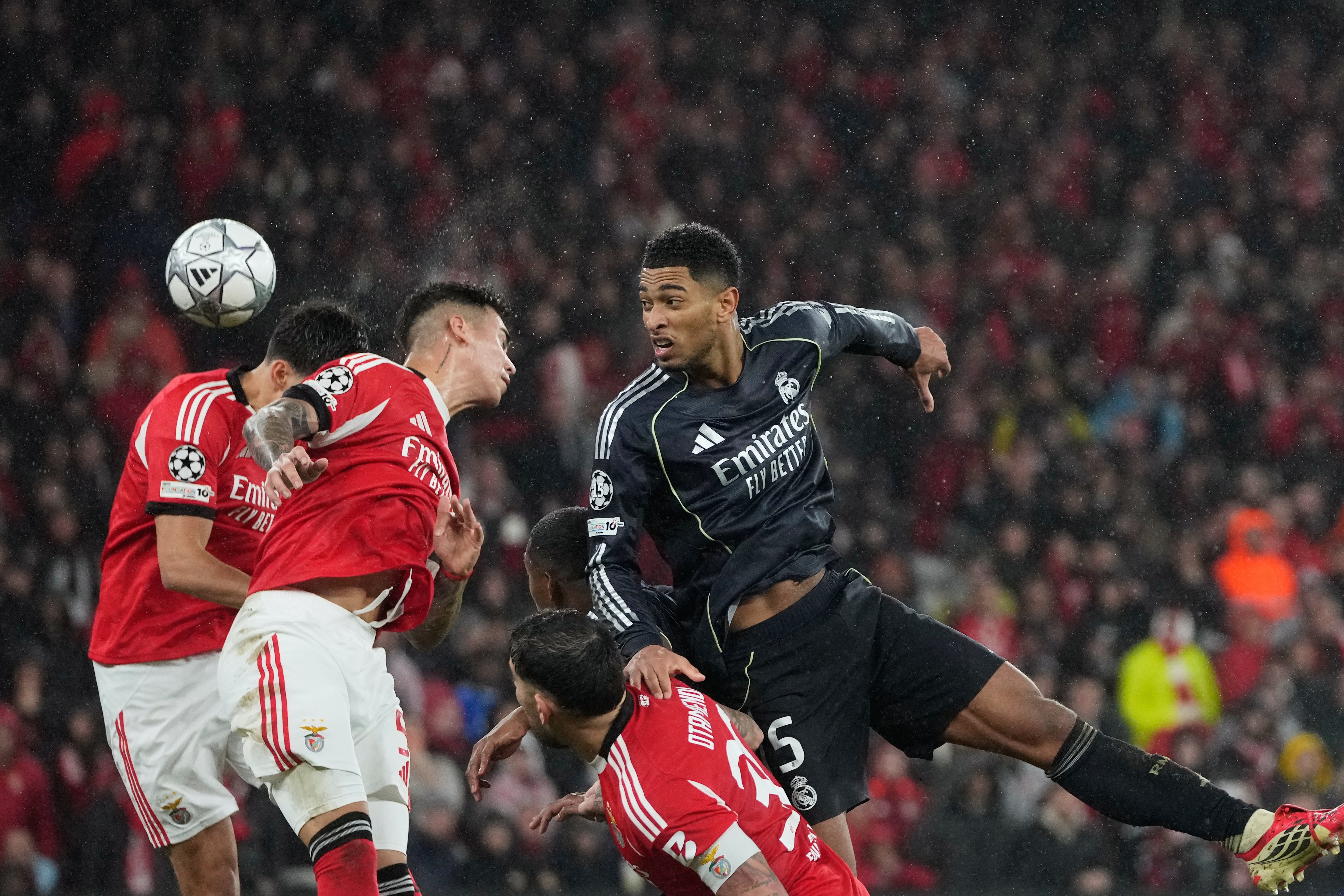 Real Madrid's Jude Bellingham, right, attempts a header at goal during a Champions League opening phase soccer match between Benfica and Real Madrid, in Lisbon, Wednesday, Jan. 28, 2026. (AP Photo/Armando Franca)