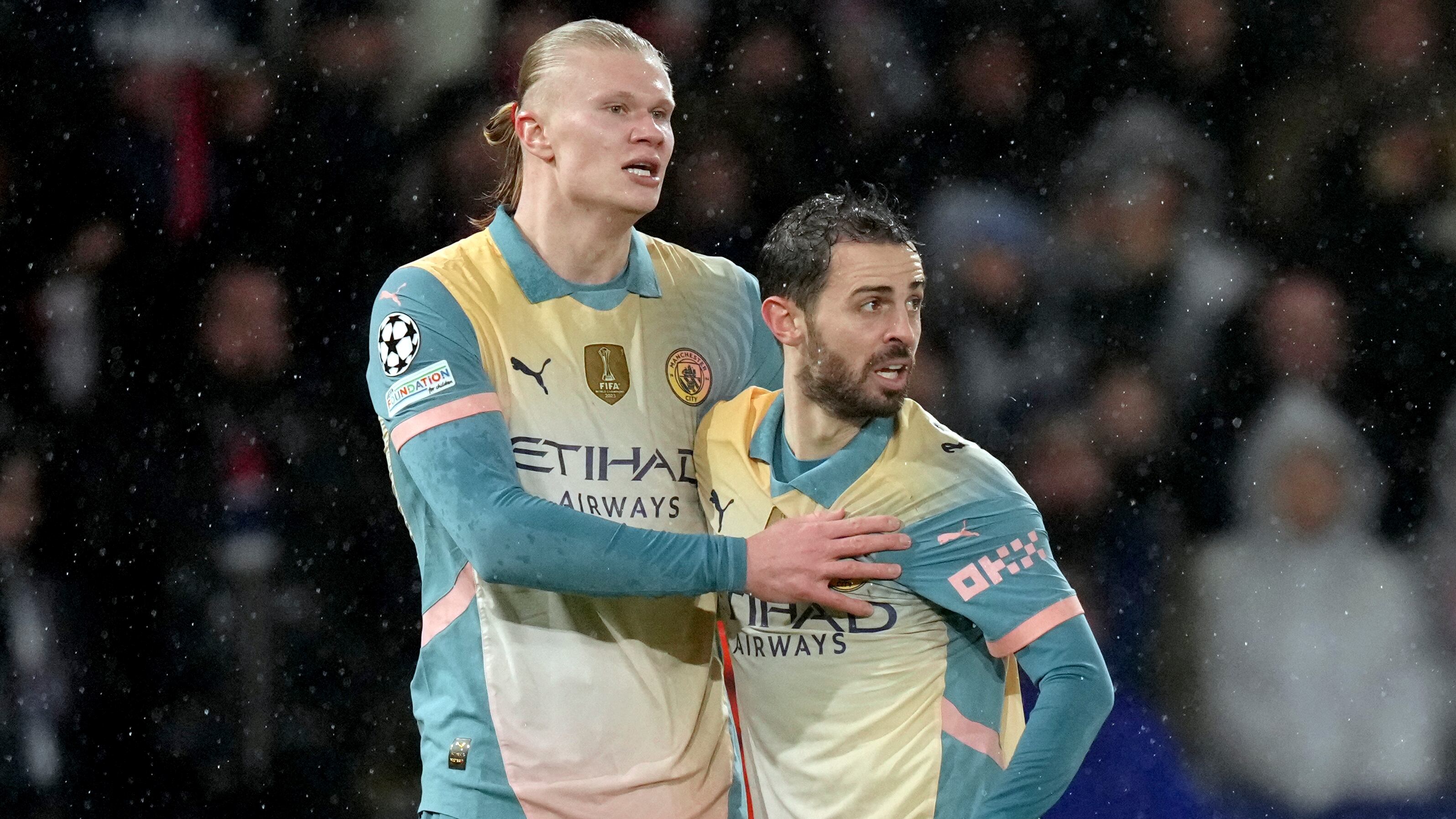 Manchester City's Erling Haaland, left, and Bernardo Silva react during a Champions League opening phase soccer match between Paris Saint-Germain and Manchester City at the Parc des Princes in Paris, Wednesday, Jan. 22, 2025. (AP Photo/Thibault Camus)