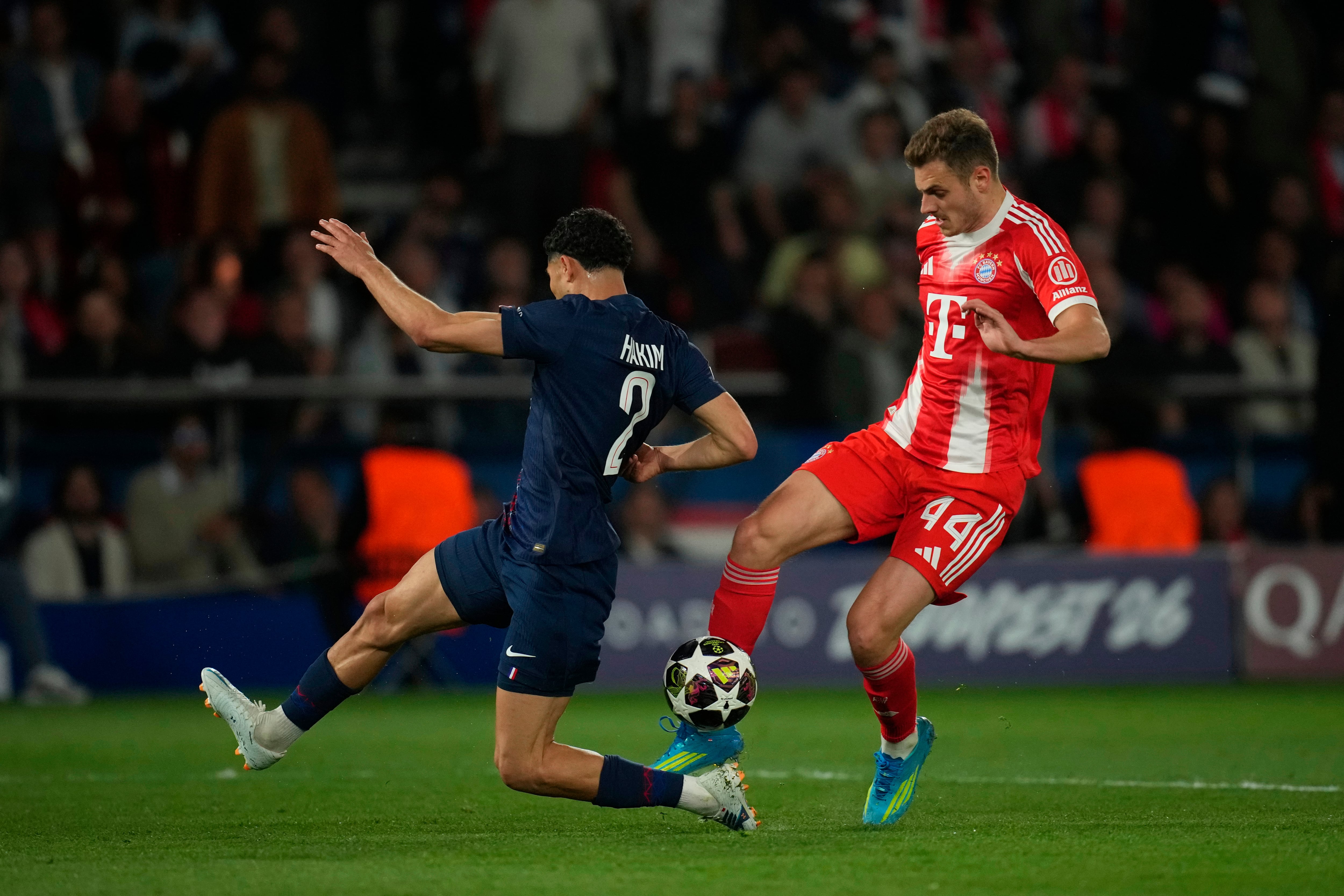 PSG's Achraf Hakimi, left, defends against Bayern's Josip Stanisic during the Champions League semifinal first leg soccer match between Paris Saint-Germain and Bayern Munich in Paris, Tuesday, April 28, 2026. (AP Photo/Christophe Ena)